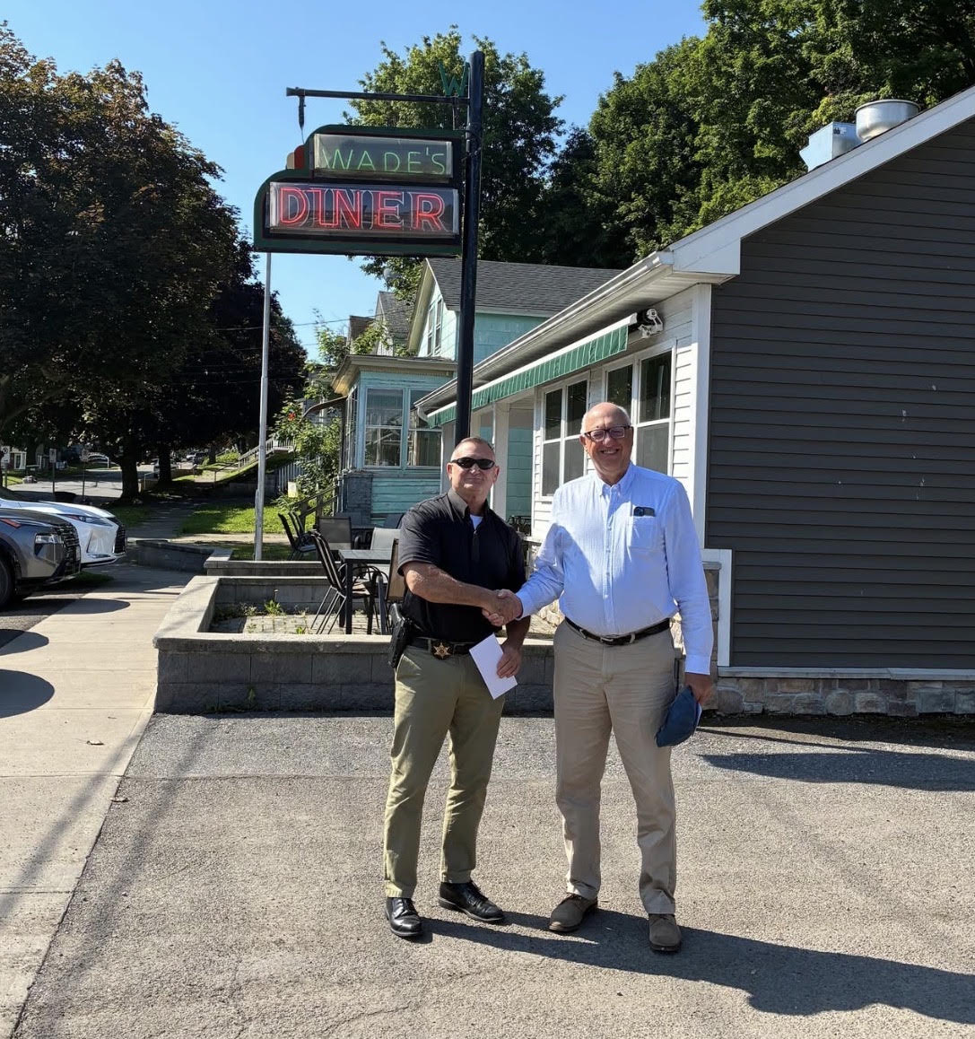 Greg Clark shaking hands with Oswego County Sheriff Don Hilton outside Wade's Diner.