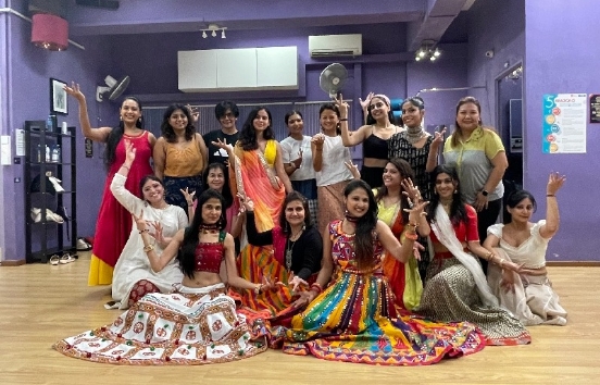 Crowd dancing Garba under fairy lights