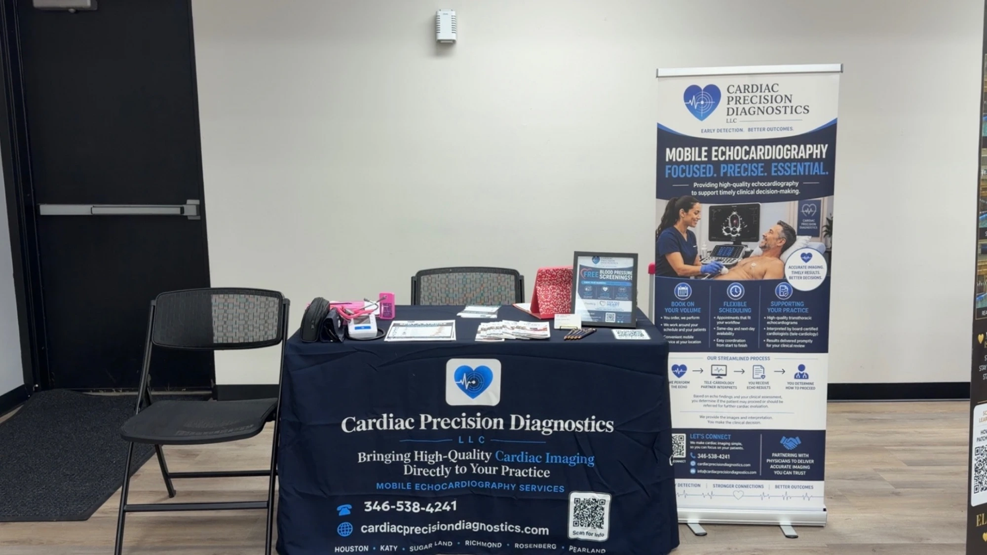 Cardiac Precision Diagnostics professional community event booth setup with informational banner.