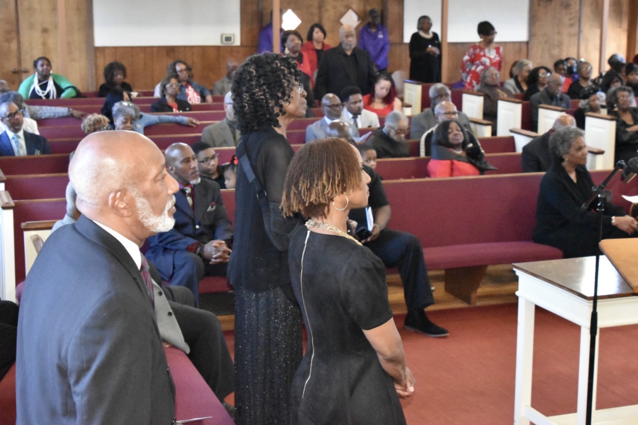 Congregation lifting hands in worship