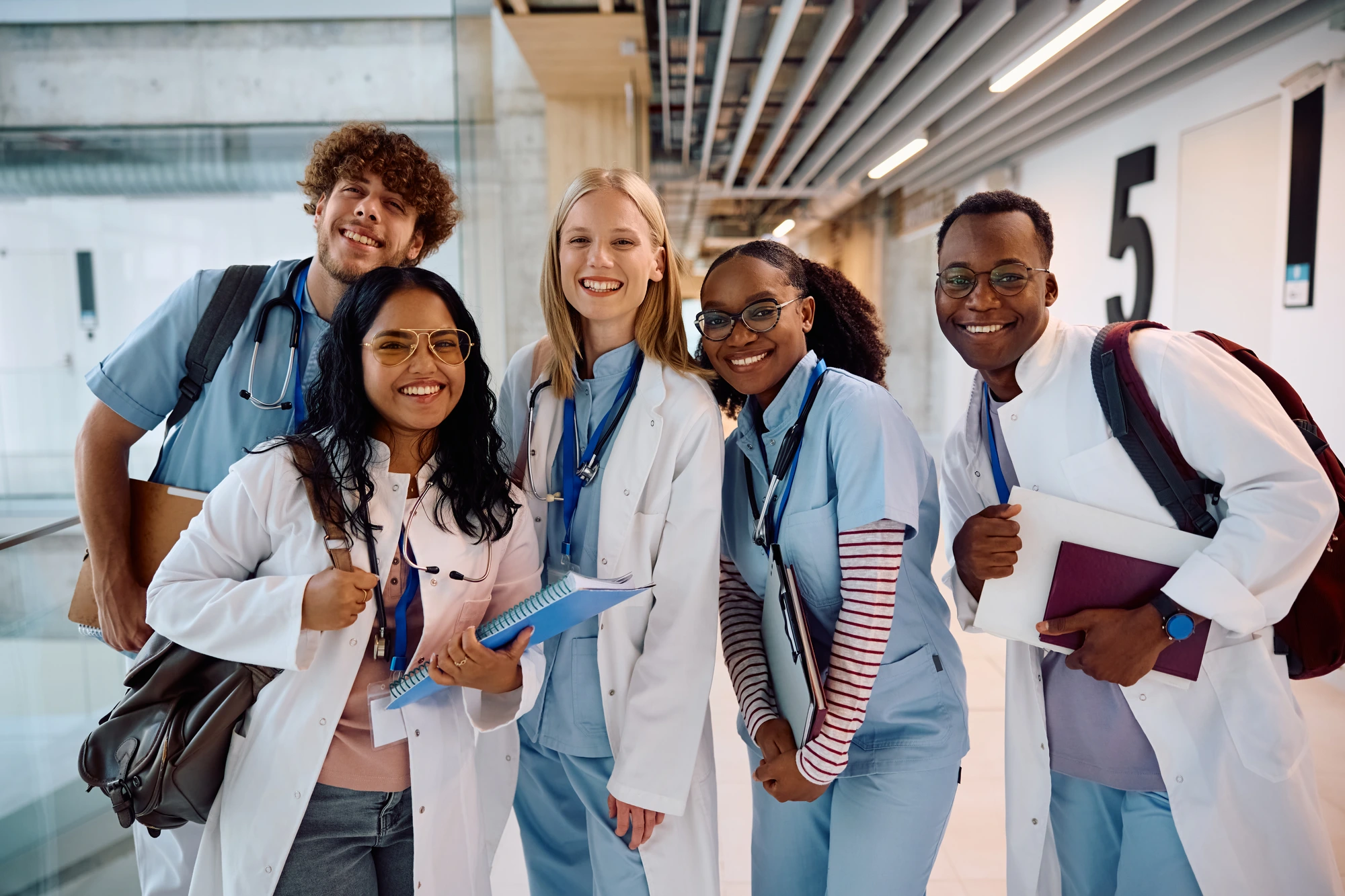 A group of medical students in scrubs and lab coats — the ambition that college affordability makes possible