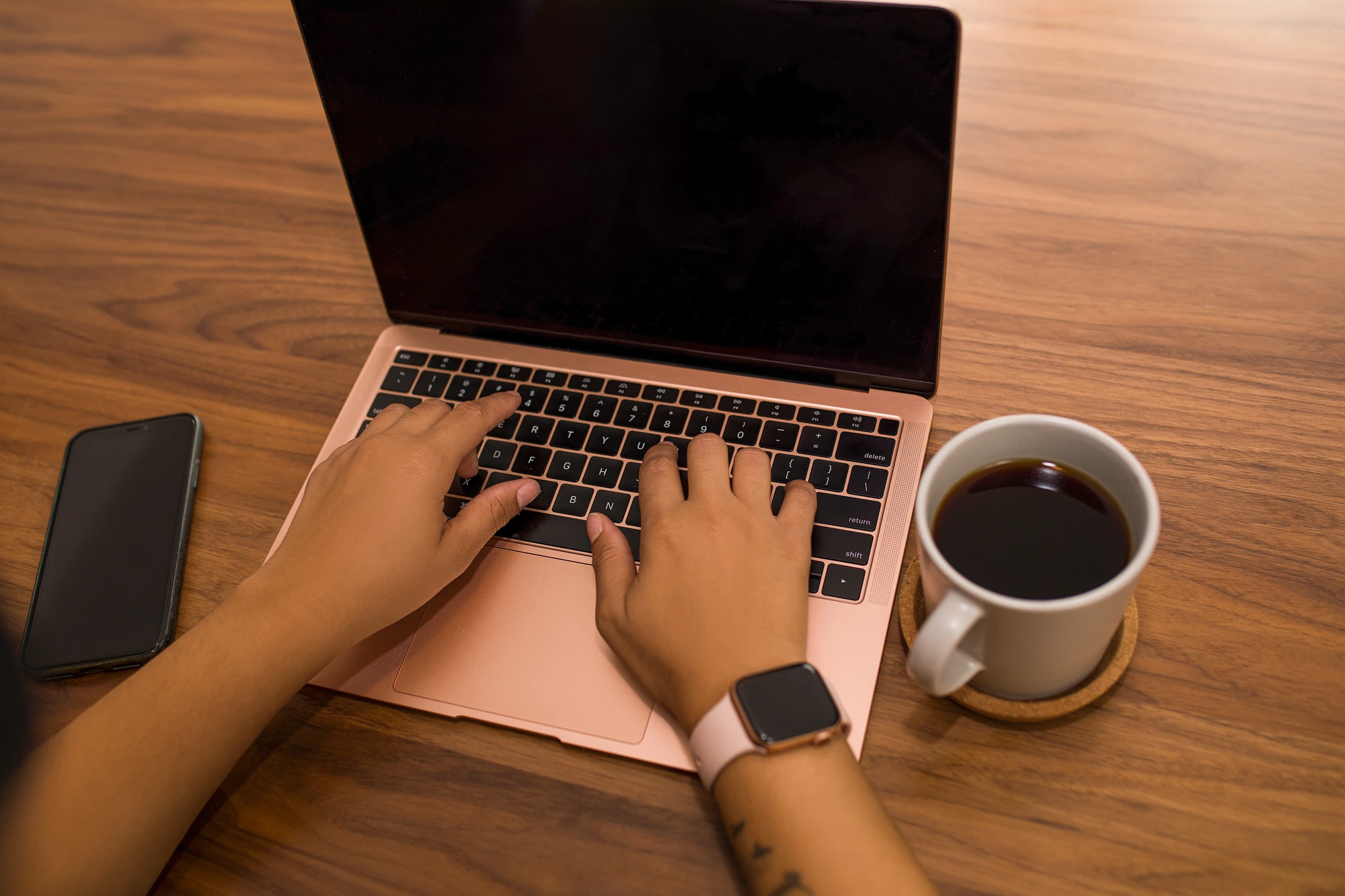 A student's hands typing on a laptop — building their page