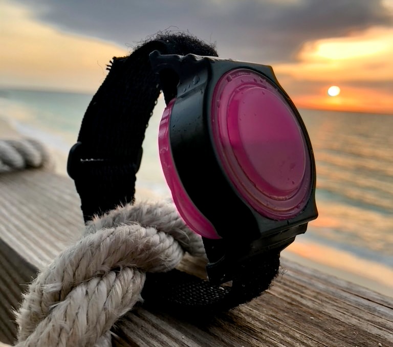A WearSpray band on rope by the ocean at sunset