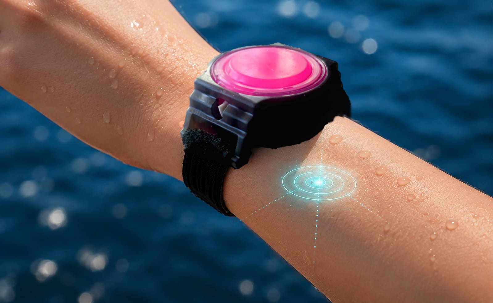 WearSpray wearable on a woman's wrist with a sensor reading the skin, shown as glowing cyan rings