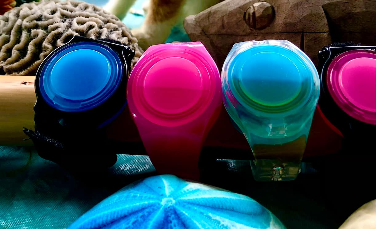 A colorful lineup of WearSpray wearables on driftwood