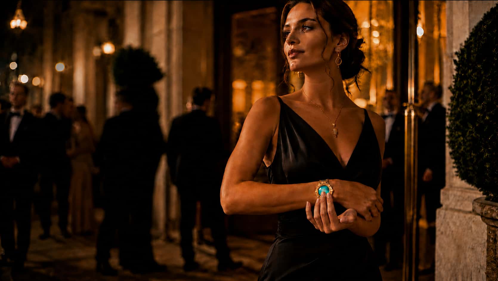An elegant woman at a gala wearing a luxury WearSpray band with a glowing face