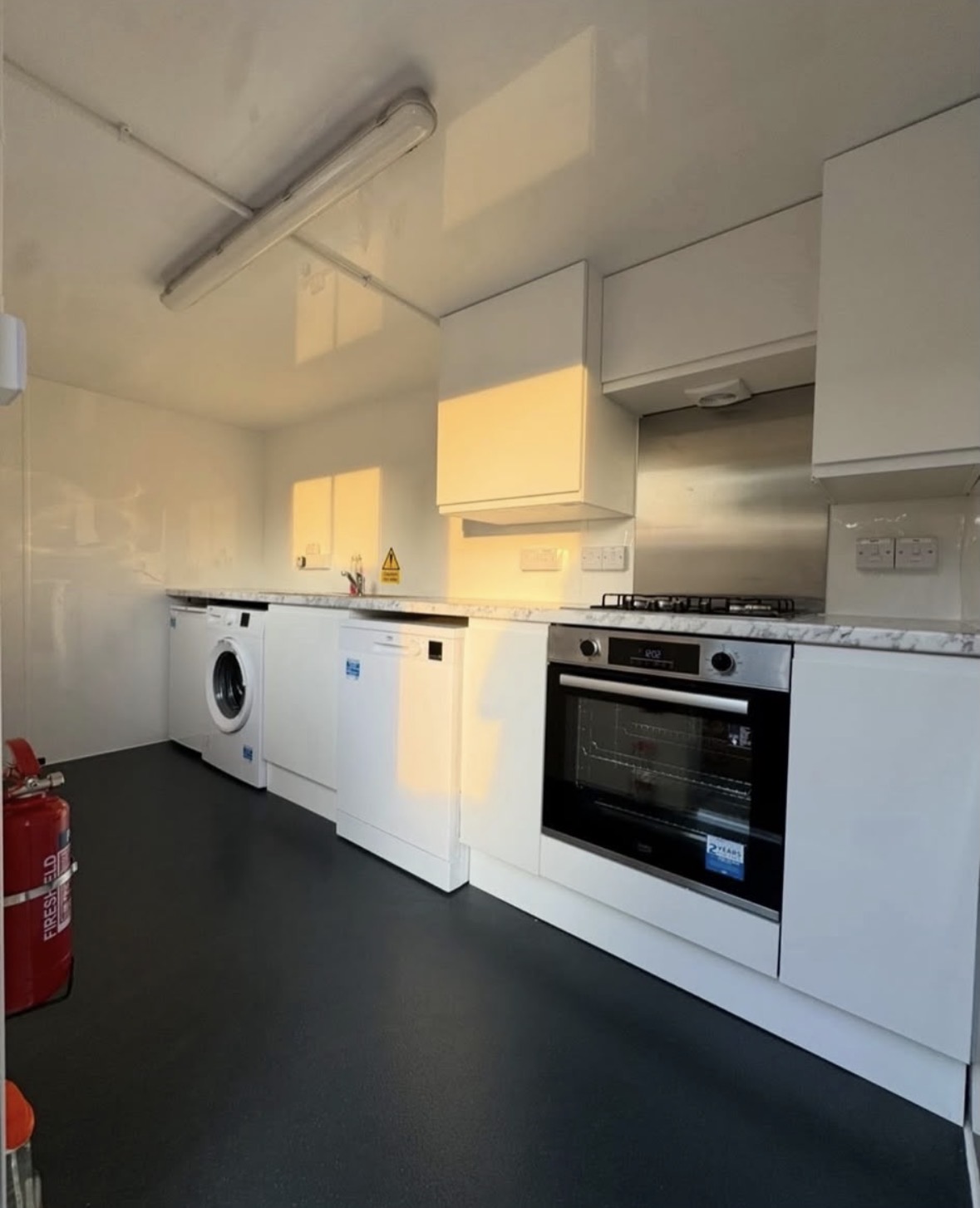 Temporary kitchen trailer set up on site with door open
