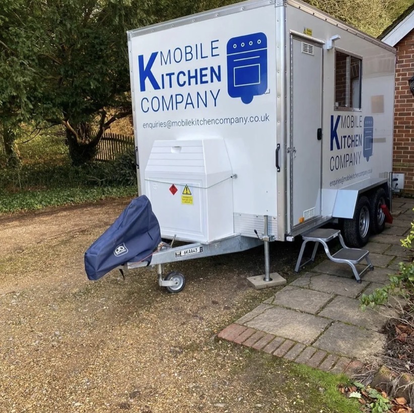 Temporary kitchen trailer with steps and door access, ready to connect on site